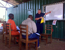 Crane & Safety explaining to Tanzanian trainees on how to read and understand duty charts for cranes when configured with offset fly jibs, Kaiso, Uganda